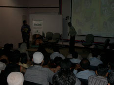Photo: a student with Galuh demonstrating safe evacuation